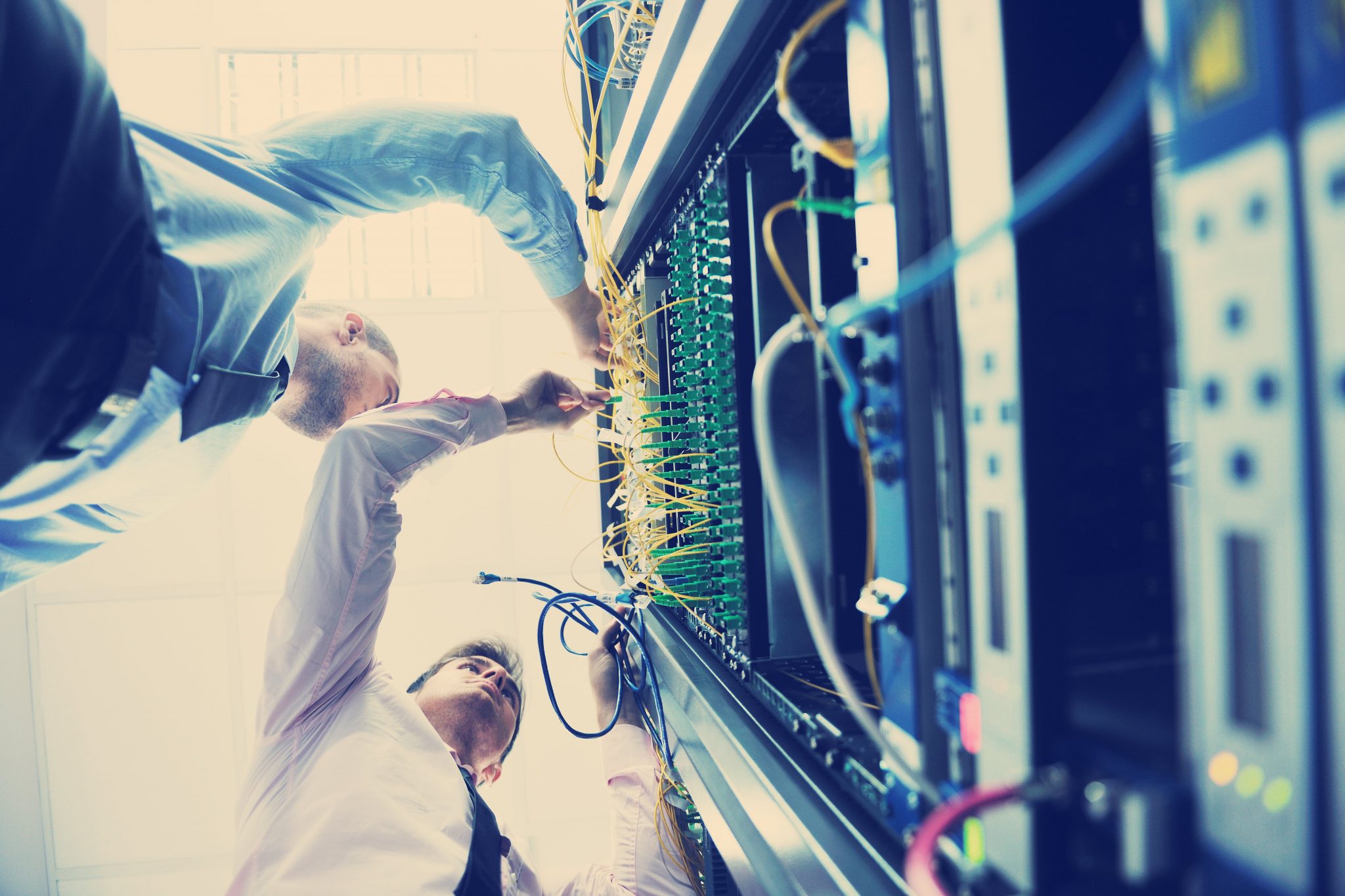 it-engineers-in-network-server-room-P5SJK6L-min